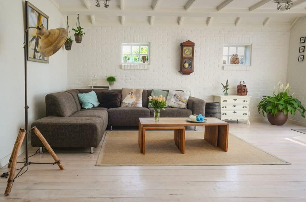 Wide-angle view of a modern minimalist living room with hidden smart home technology.