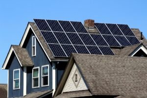 Modern eco-friendly house with solar panels on roof, smart thermostat visible through window, surrounded by green plants