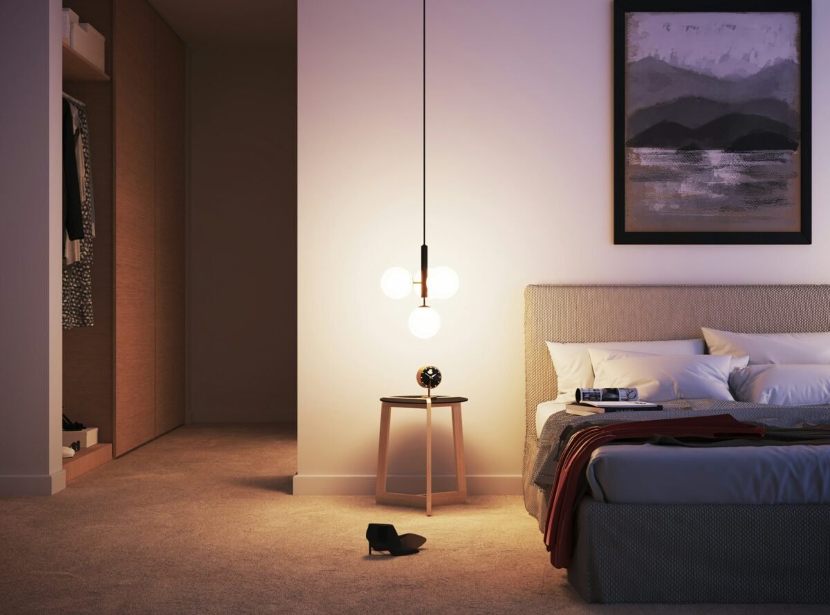 Peaceful bedroom with dim smart lighting and smart speaker on nightstand ready to play white noise