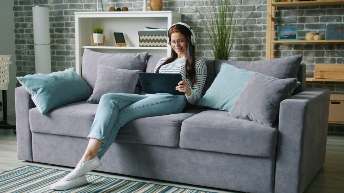 Person relaxing in living room with smart home automation creating comfortable ambiance