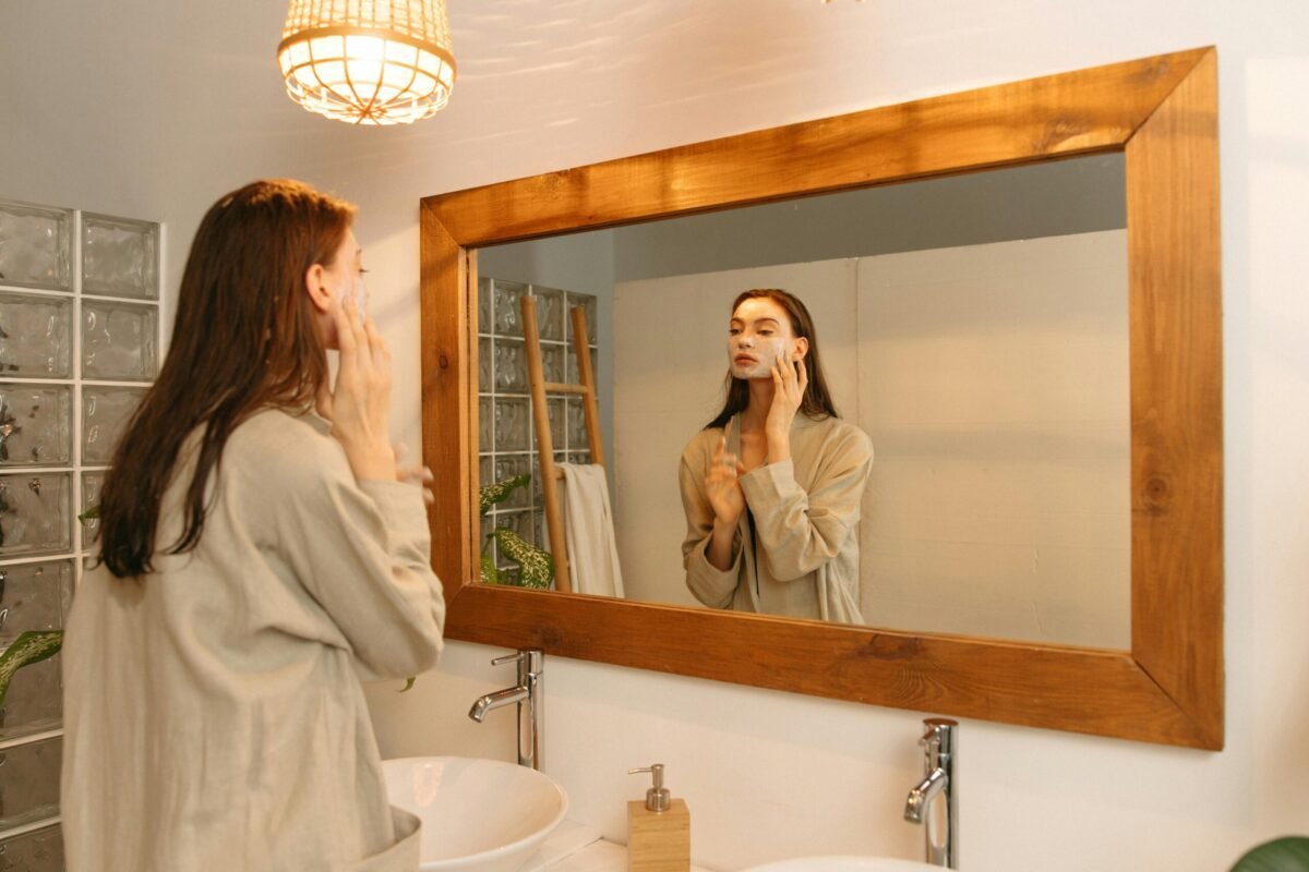 Person checking calendar and sleep data on a smart mirror during their morning bathroom routine.