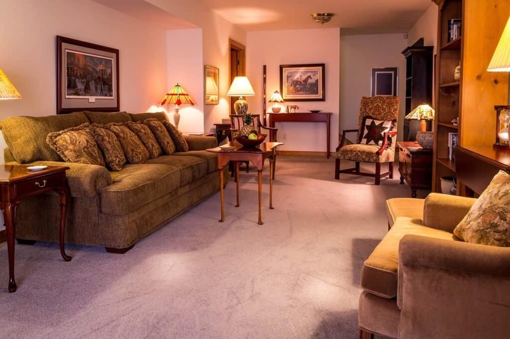 Cozy living room interior with warm amber smart lighting, comfortable sofa, and soft shadows creating a peaceful evening atmosphere
