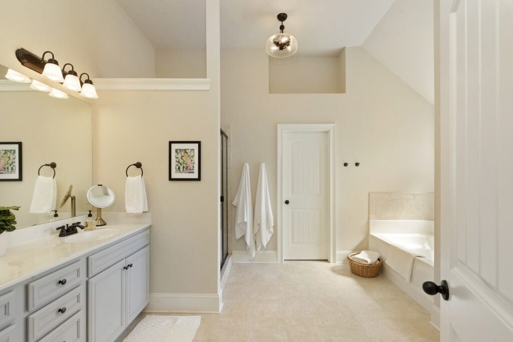 Modern luxury smart bathroom with a large mirror displaying weather and time, featuring warm ambient lighting.