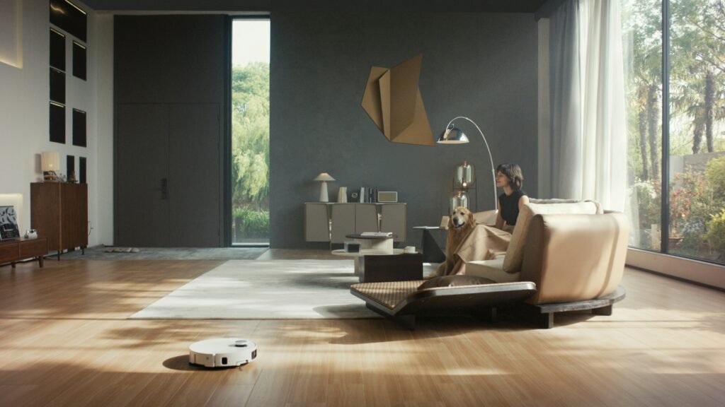 Person controlling smart home devices like lights, thermostat, and lock from a tablet in a modern living room.